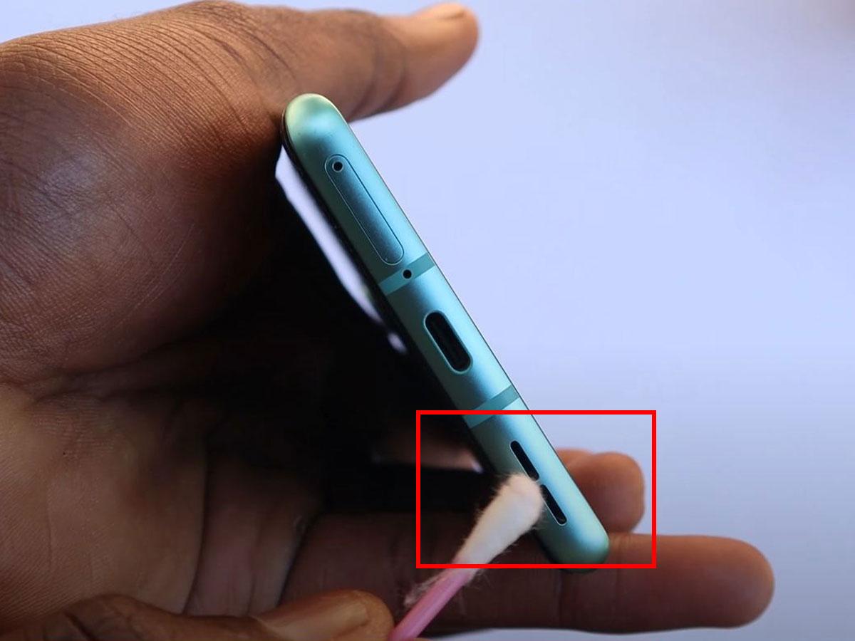 Use the cotton swab to wipe in and around the speaker holes. (From: Youtube/Philips Future)