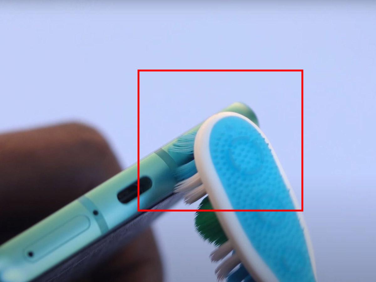Use a toothbrush to gently clean the area around the holes. (From: Youtube/Philips Future)
